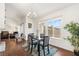 Cozy dining area with hardwood floors, chandelier, and large window offering backyard views at 680 Cervantes Dr, Henderson, NV 89014