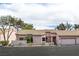 Single-story home with a two-car garage, desert landscaping, and a stucco facade at 680 Cervantes Dr, Henderson, NV 89014