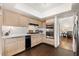 Well-lit kitchen with stainless steel appliances, ample counter space, and dark hardwood flooring at 680 Cervantes Dr, Henderson, NV 89014