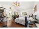 Bright main bedroom with hardwood floors, large window, and a bathroom with double sinks at 680 Cervantes Dr, Henderson, NV 89014