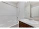 Bright bathroom featuring a shower-tub combo and vanity with a cream countertop at 7006 Sylmar Ave, Las Vegas, NV 89113