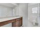 Bathroom with wood cabinets, white countertops, toilet and bathtub at 7006 Sylmar Ave, Las Vegas, NV 89113