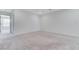 Bright, carpeted bedroom features neutral walls and a view into a connected room at 7006 Sylmar Ave, Las Vegas, NV 89113
