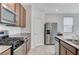 Modern kitchen featuring stainless steel appliances, granite countertops and eat-in bar at 7006 Sylmar Ave, Las Vegas, NV 89113