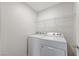 Laundry room with a wire shelf above a white washer and dryer at 7006 Sylmar Ave, Las Vegas, NV 89113