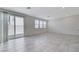 Spacious open-concept living room featuring tiled floors, neutral walls, and sliding glass doors at 7006 Sylmar Ave, Las Vegas, NV 89113