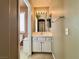 A well-lit bathroom featuring a white vanity, mirror, and coordinated fixtures creates a clean and functional space at 7173 Dravite Ct, Las Vegas, NV 89148