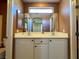 Bright bathroom featuring a double sink vanity with white cabinetry and a large mirror at 7173 Dravite Ct, Las Vegas, NV 89148