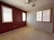 A cozy bedroom featuring neutral carpet, ceiling fan and windows with wood blinds at 7173 Dravite Ct, Las Vegas, NV 89148