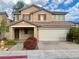 Charming two-story home featuring a tile roof, shutters, and a two-car garage at 7173 Dravite Ct, Las Vegas, NV 89148