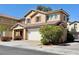 Charming two-story home featuring a tile roof, shutters, and a two-car garage at 7173 Dravite Ct, Las Vegas, NV 89148