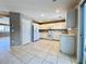 Updated kitchen with white appliances, light counters, and tile flooring at 7173 Dravite Ct, Las Vegas, NV 89148