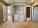 A convenient laundry area features a white washer and dryer, neatly arranged with a shelf above at 7173 Dravite Ct, Las Vegas, NV 89148