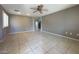 Spacious living room with tile floors and a ceiling fan at 7173 Dravite Ct, Las Vegas, NV 89148