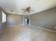 Open living room with tile flooring, ceiling fan, and access to staircase at 7173 Dravite Ct, Las Vegas, NV 89148