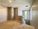 Upstairs loft area featuring neutral carpet, natural lighting, and access to stairs at 7173 Dravite Ct, Las Vegas, NV 89148
