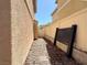 Narrow side yard with gravel and a view of the neighboring house at 7173 Dravite Ct, Las Vegas, NV 89148