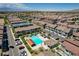 Aerial view of a meticulously designed community featuring a sparkling pool, lush landscaping, and modern townhomes at 7320 N Decatur Blvd # 5, Las Vegas, NV 89131