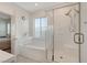 Bright bathroom featuring a glass shower and separate soaking tub under a large window at 7320 N Decatur Blvd # 5, Las Vegas, NV 89131