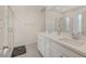 Stylish bathroom with dual sinks, quartz countertops, a glass-enclosed shower, and tile flooring at 7320 N Decatur Blvd # 5, Las Vegas, NV 89131