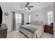 Calm bedroom with neutral tones, a ceiling fan, soft carpet, and ample natural light from the windows at 7320 N Decatur Blvd # 5, Las Vegas, NV 89131