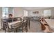 Open-concept dining area with elegant wooden table set and views into the comfortable living room at 7320 N Decatur Blvd # 5, Las Vegas, NV 89131