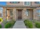 Inviting front porch with stone accents and a cozy seating area with an outdoor table and chair at 7320 N Decatur Blvd # 5, Las Vegas, NV 89131