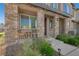 Inviting front porch with stone pillars, outdoor seating, and lush landscaping at 7320 N Decatur Blvd # 5, Las Vegas, NV 89131