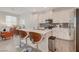 Bright kitchen features white cabinets, stainless appliances, and quartz countertops with seating at the island at 7320 N Decatur Blvd # 5, Las Vegas, NV 89131