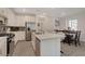 Bright kitchen with quartz countertops, stainless appliances, and a stylish center island overlooking the dining area at 7320 N Decatur Blvd # 5, Las Vegas, NV 89131