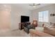 Cozy living room with a large window for natural light, neutral carpet, and comfortable furniture at 7320 N Decatur Blvd # 5, Las Vegas, NV 89131