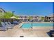 Relaxing community pool with plenty of lounge seating and umbrellas, surrounded by townhomes at 7320 N Decatur Blvd # 5, Las Vegas, NV 89131