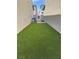 Narrow backyard featuring artificial turf and gated access at 7323 Sunray Point St, North Las Vegas, NV 89084