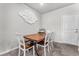 Inviting dining room area with modern light fixture and a wood dining table at 7323 Sunray Point St, North Las Vegas, NV 89084