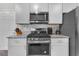 Beautiful kitchen with gas range, granite countertops, and stainless steel appliances at 7323 Sunray Point St, North Las Vegas, NV 89084