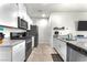 Well-equipped kitchen featuring white cabinets, granite countertops, and stainless steel appliances at 7323 Sunray Point St, North Las Vegas, NV 89084