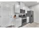 Bright kitchen features stainless steel appliances, granite countertops and white cabinetry at 7323 Sunray Point St, North Las Vegas, NV 89084