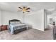 Spacious main bedroom with a comfortable bed and ceiling fan at 7323 Sunray Point St, North Las Vegas, NV 89084
