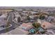 Aerial view of a neighborhood showcasing lush landscaping, community pools, and well-maintained homes at 810 Roaring Falls Ave, Henderson, NV 89052