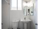 Clean bathroom featuring a pedestal sink, modern fixtures, and a bright window at 810 Roaring Falls Ave, Henderson, NV 89052