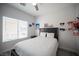 Bright bedroom with natural light, a comfortable bed, and stylish wall decor at 810 Roaring Falls Ave, Henderson, NV 89052