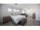 Bright bedroom with natural light, and a gray sectional couch creating a relaxing retreat for guests or Gathering at 810 Roaring Falls Ave, Henderson, NV 89052