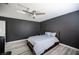 Comfortable bedroom featuring gray walls, wood floors, and a bedframe with built-in storage at 810 Roaring Falls Ave, Henderson, NV 89052