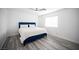 Simple bedroom with a blue bed frame, ample natural light, and modern flooring at 810 Roaring Falls Ave, Henderson, NV 89052