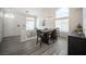 Open dining room with a modern light fixture, large windows, and access to the upstairs and front door at 810 Roaring Falls Ave, Henderson, NV 89052