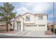Two-story home featuring a three-car garage, a well-maintained yard and a welcoming facade at 810 Roaring Falls Ave, Henderson, NV 89052