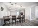 Bright, open-concept kitchen featuring a breakfast bar with pendant lighting and modern finishes at 810 Roaring Falls Ave, Henderson, NV 89052