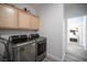 Convenient laundry room with modern washer/dryer units and ample cabinet space at 810 Roaring Falls Ave, Henderson, NV 89052
