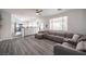 Spacious living room with large window, comfortable seating, and modern gray flooring at 810 Roaring Falls Ave, Henderson, NV 89052