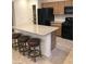 Open kitchen with granite countertops, wooden cabinets and black appliances at 8111 Switchback Run St, Las Vegas, NV 89166